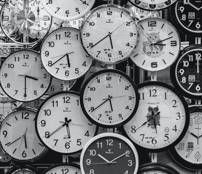 black and white photo of clocks