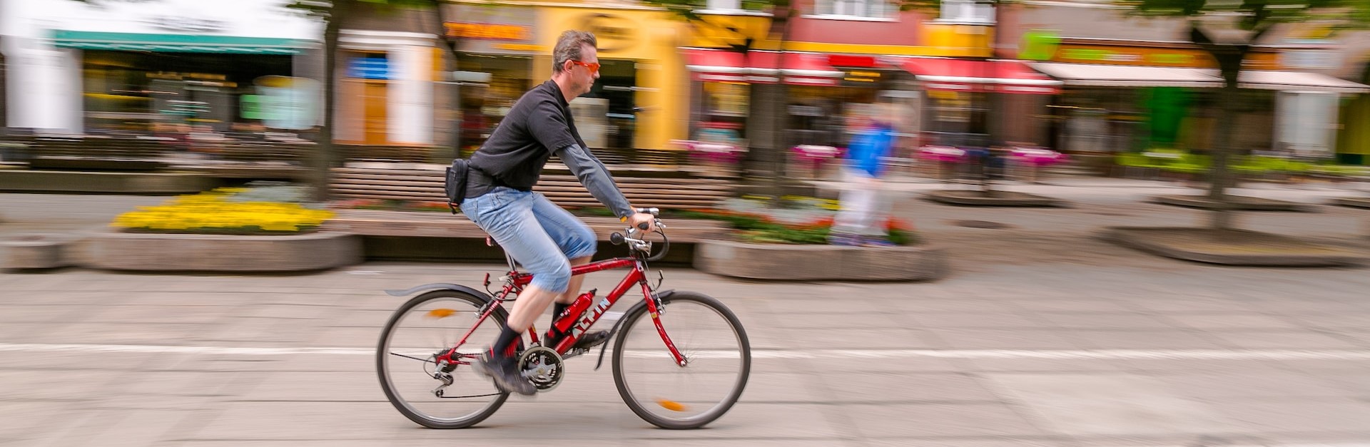 man speeding by on a bicycle
