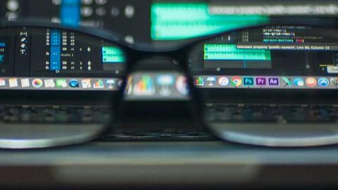 sinister and complicated computer screen seen through a pair of glasses