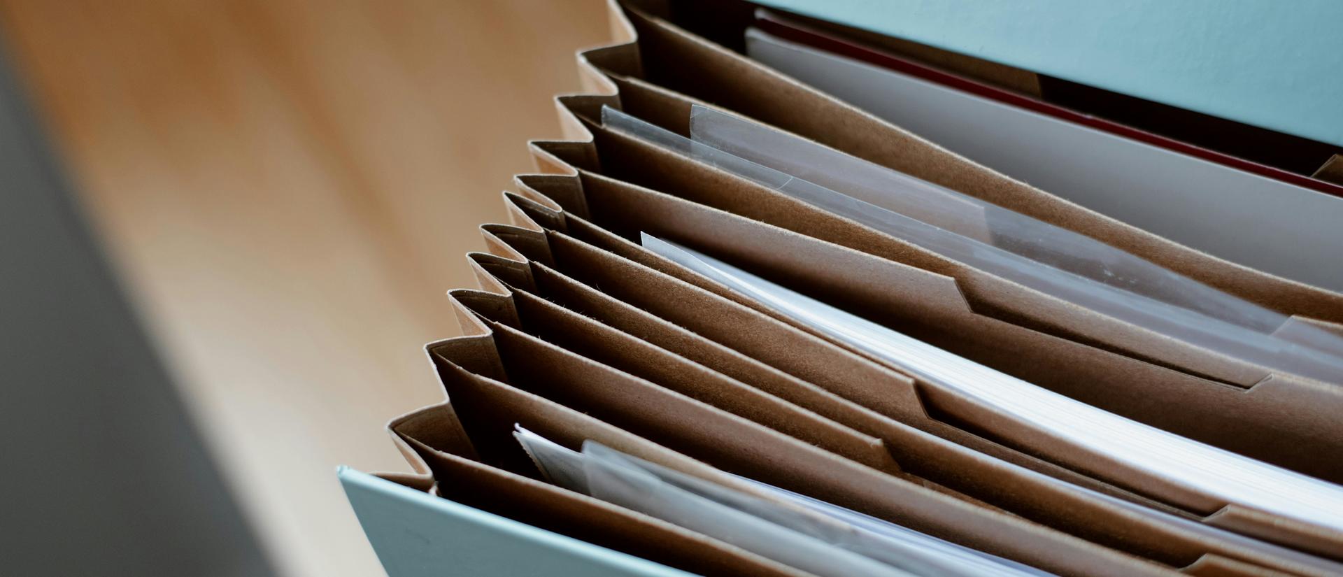 Accordian file folder holding paper files