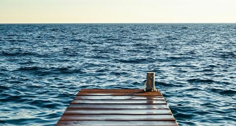 dock jutting into water out to horizon